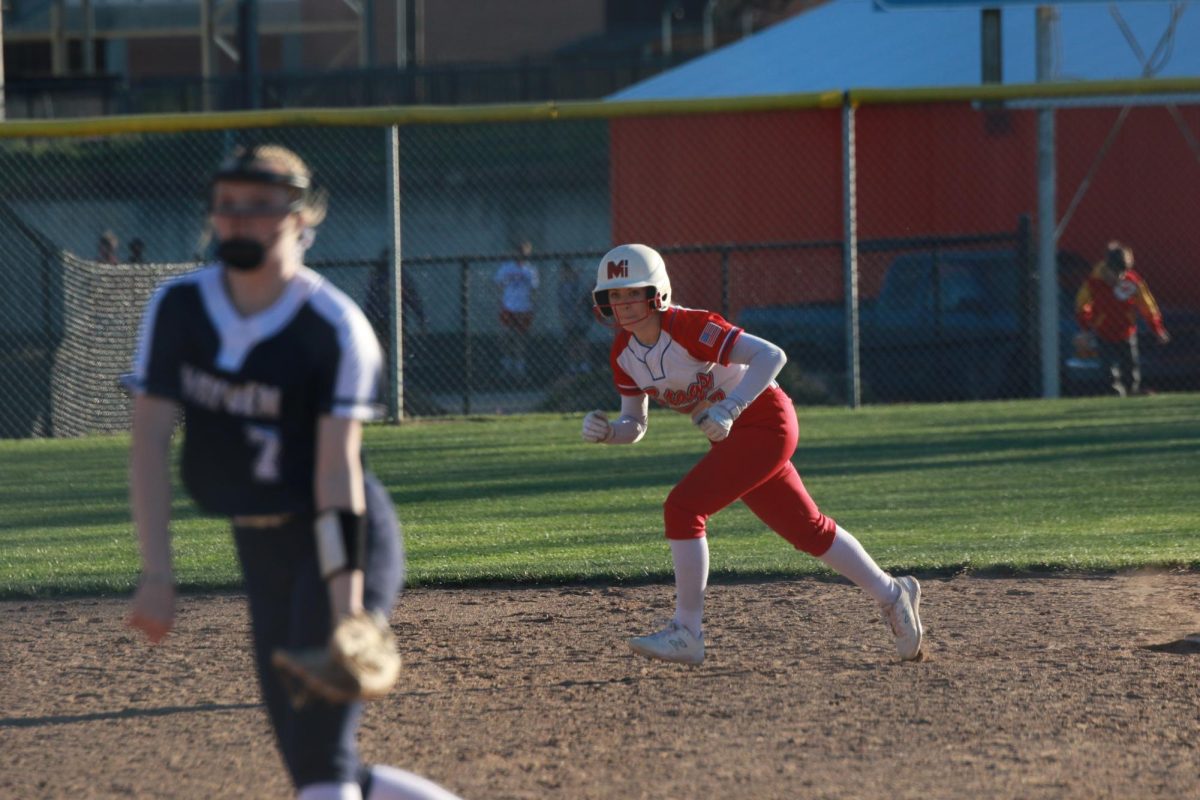 Ready to steal the base, senior Kathryn Kolarik showcases her leadership. She has played club teams for much of her life and has competed  for Miege since freshman year. 