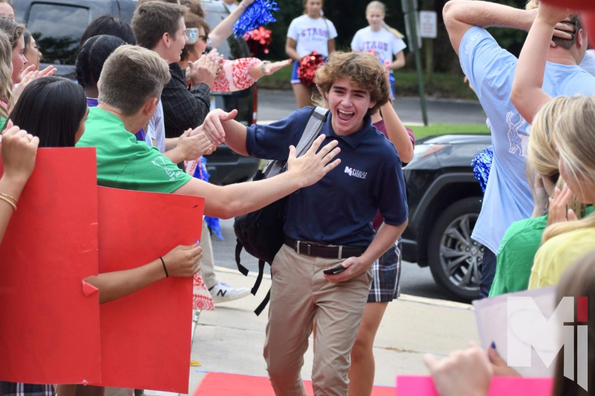 Cheering along with the upperclassmen, freshman Henry Vani is greeted by the cheering upperclassmen on orientation day. “I was feeling really excited on freshmen welcome day, I saw my friend Garrett who I went on Prayer and Action with and it was awesome,” Vani said. “All the seniors were so welcoming, and I felt so proud to finally be a Stag.”