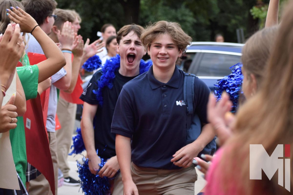 While not knowing what to expect, freshman Grant Gelhaus walks down the red carpet into his new school year. “Freshman orientation was super fun and it really influenced my vision of Miege,” Gelhaus said. “Miege feels pretty exciting, even though I was nervous walking down the red carpet on my first day.”