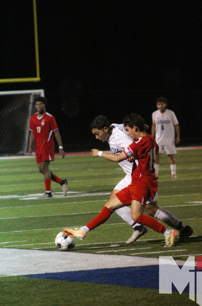 Game face on, senior Paul Rodriguez fights for the ball against a player from Harmon during the Oct. 17 match. “I was a ball hogger my freshman year, so I feel like I've learned to share the ball more since then,” Rodriguez said. The boy’s soccer team defeated Harmon with a final score of 4-1.