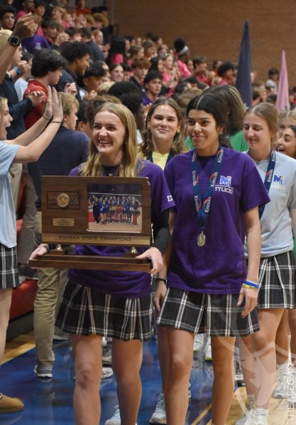 Senior Kirston Verhulst leads the girls volleyball team through the gym to celebrate their third consecutive state championship win. “I was a little bit nervous walking around the gym because there were a lot of people in there, but it was nice to see the support from everyone after we won,” Verhulst said. Verhulst has focused on leading the team by example, working hard to show the underclassmen how the team needs to play in order to win. “It was a pretty intense game, but our level of competitiveness really showed.”