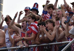 Cheering on the football team, senior Carter Stevens enjoys his role as one of the leaders of the student section. "It's different as a senior, because you're having to lead student sections and start chants instead of following them," Stevens said. "I enjoy going to the football games because of the spirit Miege has with dressing up in themes and cheering everyone on." 