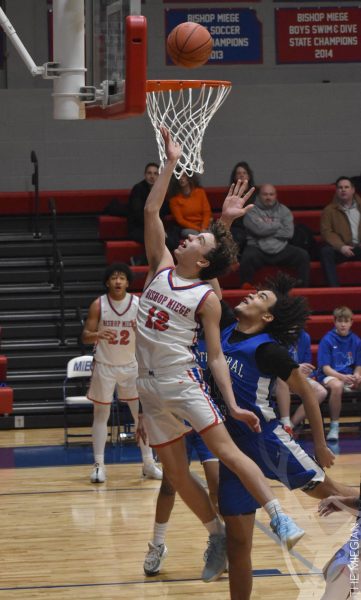 Driving in for a layup, sophomore Liam Tesmer scores for the Stags at the boys basketball game against KC Central on Jan. 21. “I got lucky and was able to really get our team going,” Tesmer said. “As a team we are really hopeful for the rest of the season and everyone is really starting to find their role.”