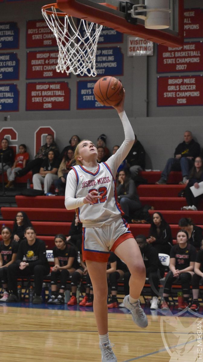 Preparing to dunk, senior Kirston Verhulst scores off a fast break during the girls basketball game against Lawrence on Jan. 21. “It has been amazing to play for a program with such a great tradition,” Verhulst said. Verhulst is committed to playing D1 basketball at Middle Tennessee State University next year, but is still determined to finish out her high school career strong. “I'm hoping to get one more state championship with this group of girls, because they are very special to me.”