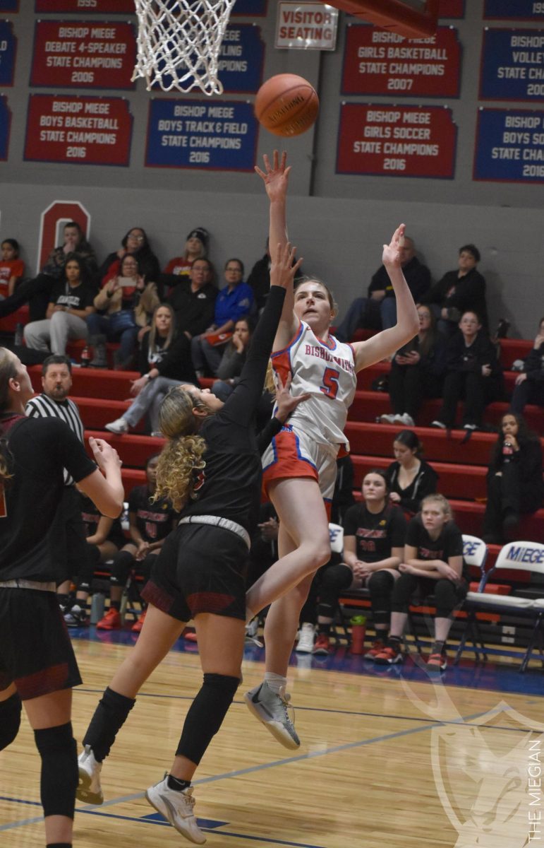 After driving into the paint, junior Mary Grant floats the ball into the hoop. Grant has an optimistic outlook for the rest of the season and has full confidence in her teammates. “I think we keep getting better and better, and we work well together,” Grant said. “I feel really strong about the team, and I think we have all the pieces to win.”