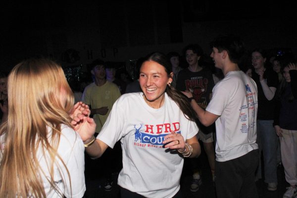 Keeping the spirit up, senior Emilia Buck grooves during the seventh and eighth-grade mixer. “I think all of us having fun helped the seventh and eighth graders,” Buck said. “We kept our energy at its best, so their energy would be high, and they would have a great time.”