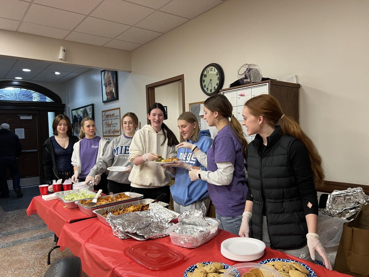 Making a plate for a Sheffield Place resident, Catholic Women's Empowerment Club members volunteer at the second annual dinner held in January. 