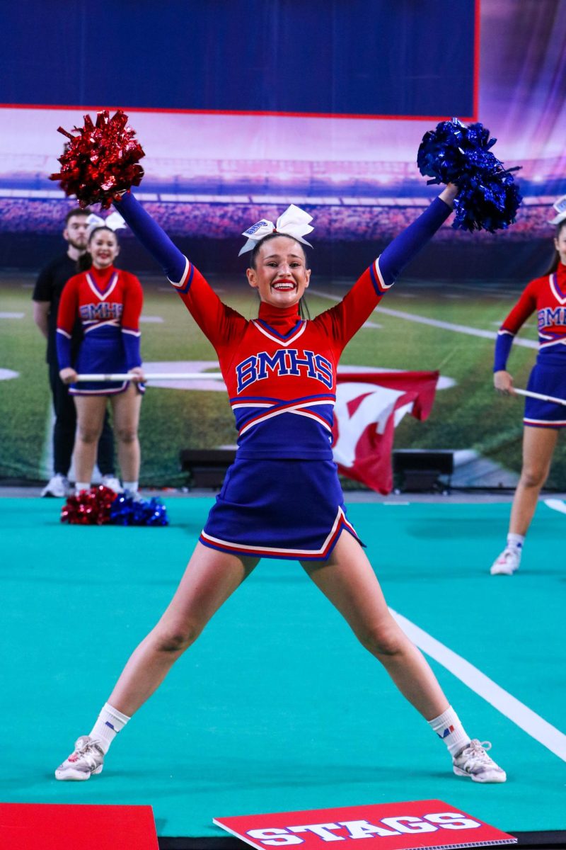 Big finish. Team captain Mary Noblitt leaves everything on the mat as she strikes her final pose during their state performance in Topeka on Nov. 22.  
“I am super proud of the hard work every girl put on the mat during the months of preparation and during the final performance,” Noblitt said. “Every single girl has something amazing to add to our team this year, which is what makes it so special.”
