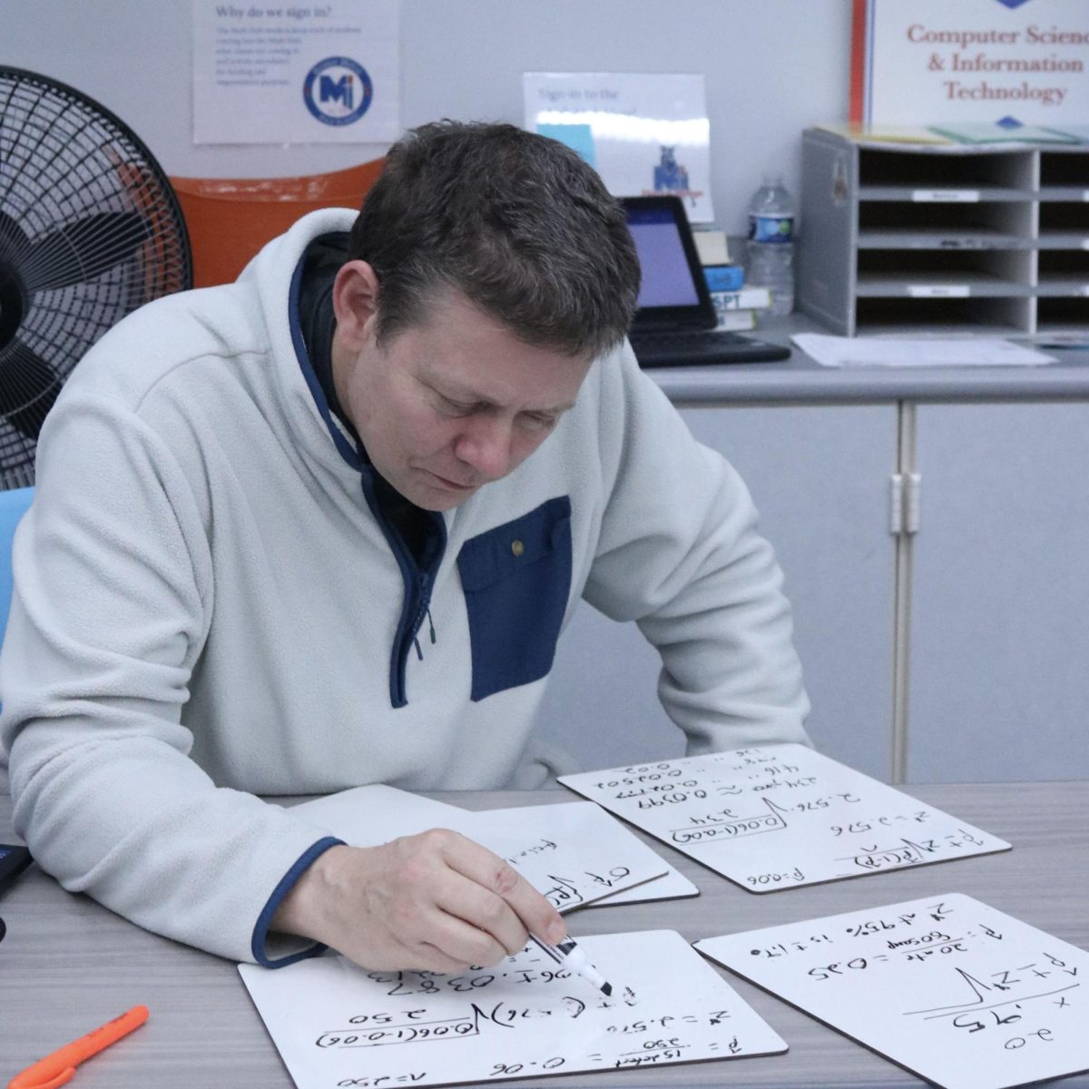 New statistics teacher, Jeffery Reed works out a challenging math problem on whiteboards in the media center. "It is hard to explain things that I find very easy to understand that I know in my head, and having to go through and practice them to help students." Reed said.
