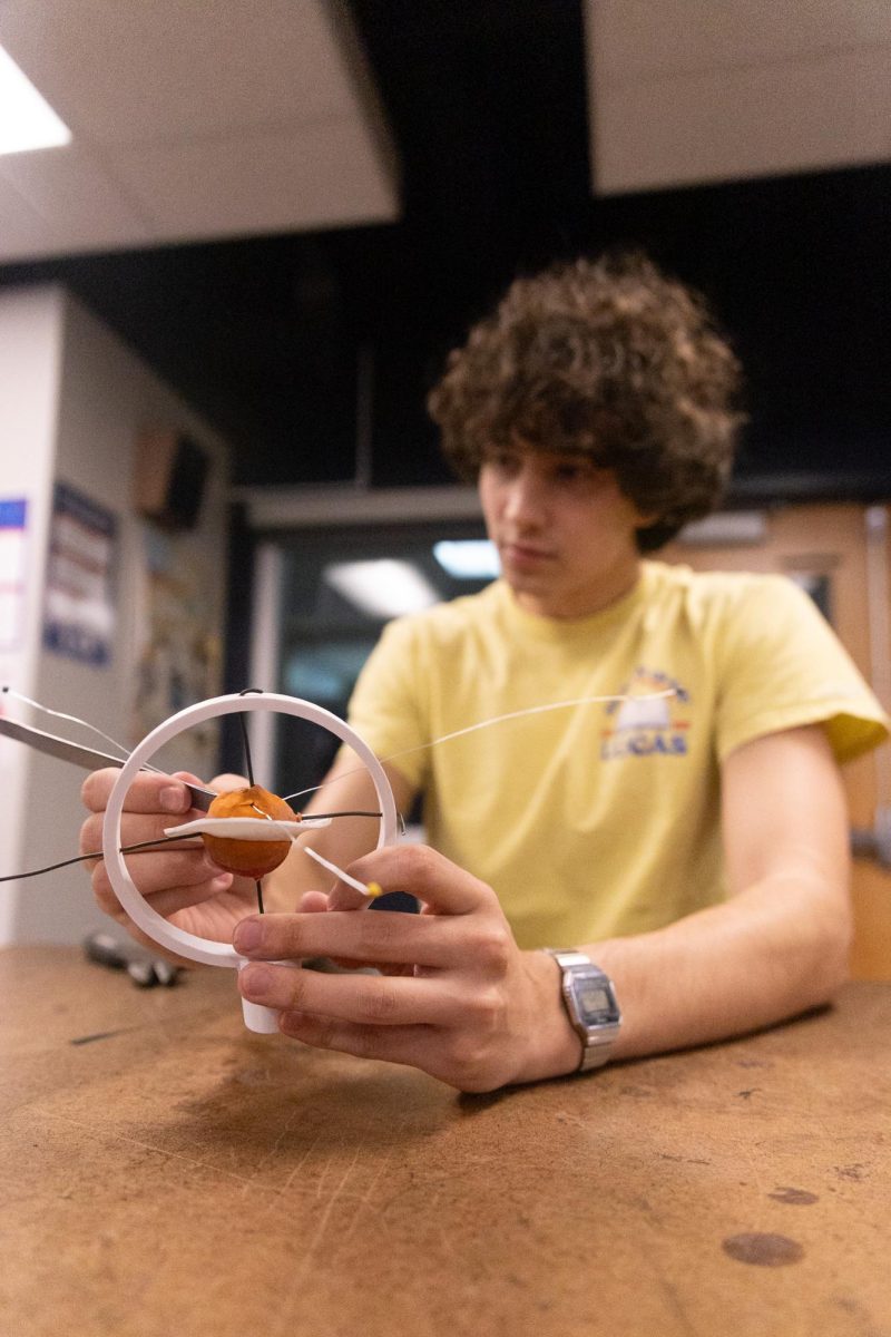 Senior Victor Axtell constructs his model of the planet Jupiter. Students assemble scale models of the solar system and surrounding celestial bodies in Aerospace Engineering. “The problem solving skills that I learned through engineering classes are very helpful, and I think they’ll carry me very far,” Axtell said.