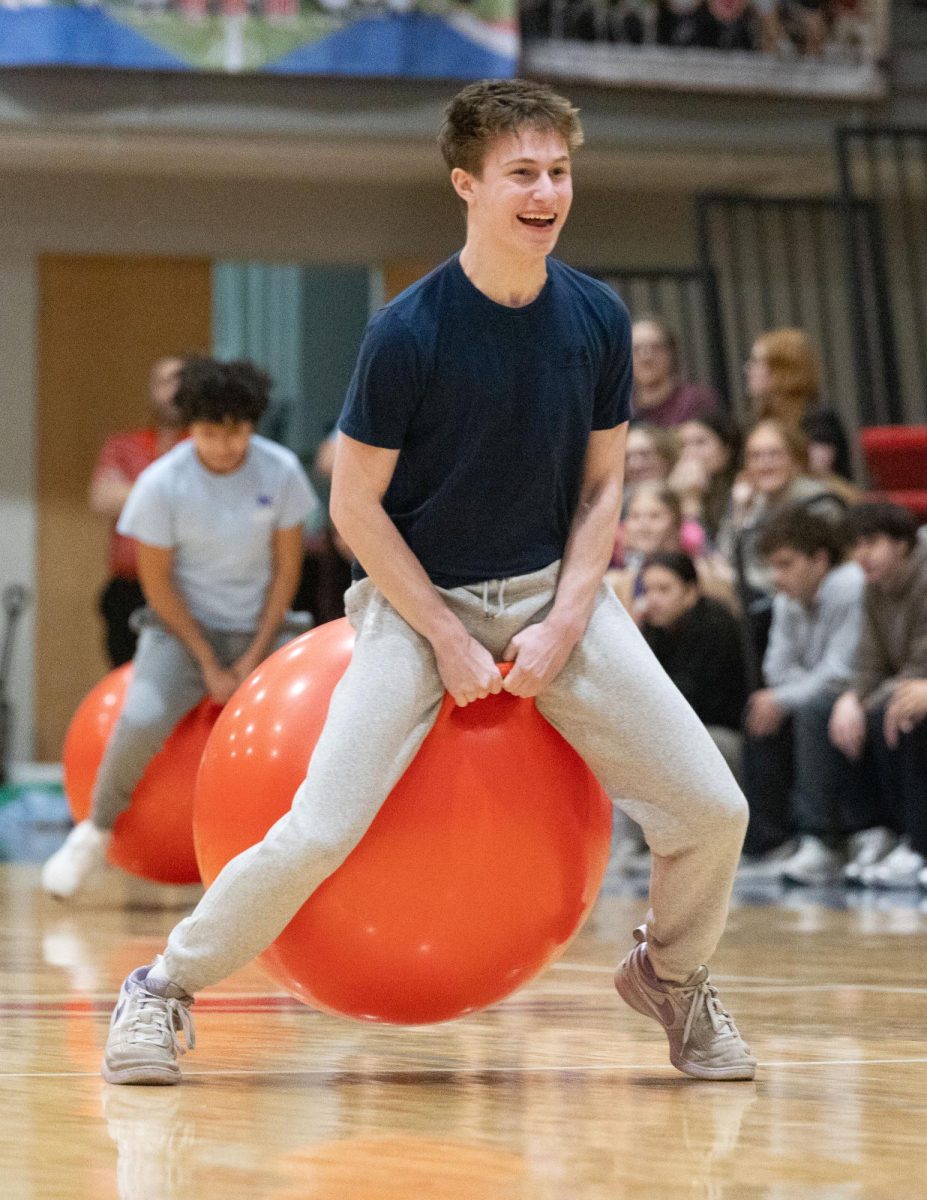 Herd Hustle. Junior Griffith Meyer races to get Tylicki ahead in the bouncy-ball race herd competition on Feb. 12. “The atmosphere was electric,” Meyer said. “I heard Devyn screaming my name and everyone else hyping me up, so I was just overjoyed.” 